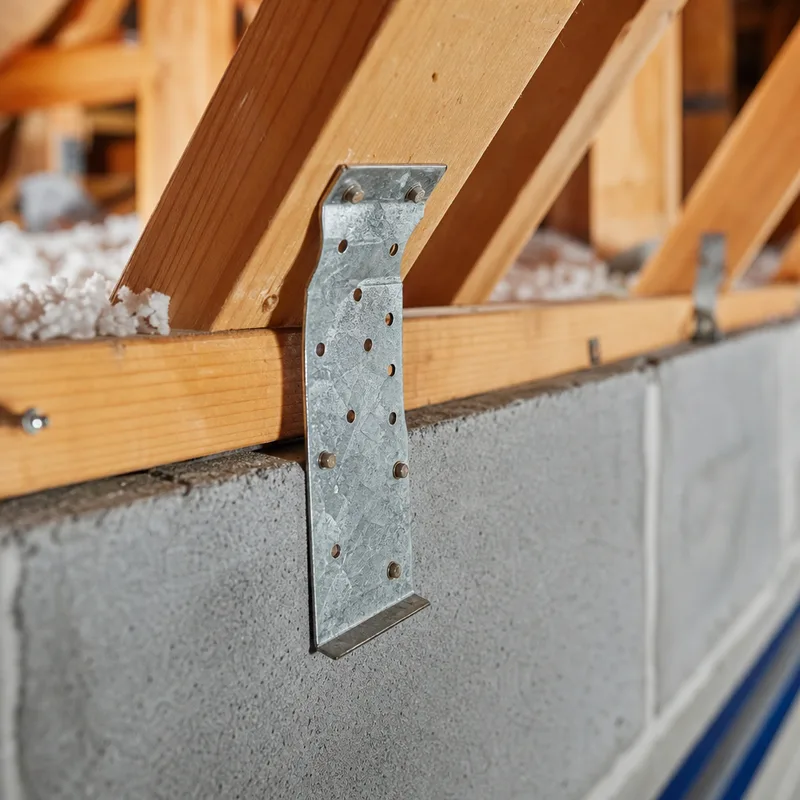 Metal connector at a truss-to-wall area photographed for form documentation